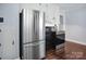 Modern kitchen featuring stainless steel refrigerator and appliances complemented by white cabinets and stylish flooring at 2108 Twin Ave, Gastonia, NC 28052