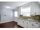 Bright kitchen featuring white cabinets, granite countertops, wood-look flooring, and ample natural light at 2108 Twin Ave, Gastonia, NC 28052