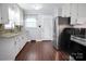 Well-appointed kitchen with modern stainless steel appliances, white cabinets, and stylish wood-look flooring at 2108 Twin Ave, Gastonia, NC 28052