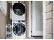 This laundry area features a stacked washer and dryer set and a metal shelving rack at 2108 Twin Ave, Gastonia, NC 28052