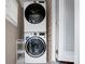 This laundry area features a stacked washer and dryer set and a metal shelving rack at 2108 Twin Ave, Gastonia, NC 28052