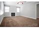 Cozy living room offering neutral decor, soft carpeting, a traditional fireplace, and bright, natural lighting at 2108 Twin Ave, Gastonia, NC 28052
