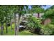 This outdoor view of the home features lush trees, landscaping, a deck, and a hot tub at 21621 Crown Lake Dr, Cornelius, NC 28031