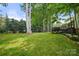 Expansive grassy backyard includes mature trees, lush landscaping and an elevated deck at 21621 Crown Lake Dr, Cornelius, NC 28031