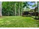 Spacious backyard features beautiful green grass and mature tree coverage for privacy at 21621 Crown Lake Dr, Cornelius, NC 28031