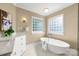 Bright bathroom featuring vanity, soaking tub beneath two privacy windows at 21621 Crown Lake Dr, Cornelius, NC 28031