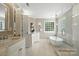 Bright bathroom with a modern glass shower, soaking tub and dual sink vanity at 21621 Crown Lake Dr, Cornelius, NC 28031