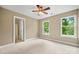 Bright bedroom featuring neutral carpet, two windows and an ensuite bathroom at 21621 Crown Lake Dr, Cornelius, NC 28031
