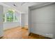 Bright walk-in closet featuring hardwood floors, natural light and shelving at 21621 Crown Lake Dr, Cornelius, NC 28031