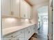 Elegant butler's pantry with white cabinets, ample counter space, and stylish backsplash at 2227 Caravan Ln # 43, Denver, NC 28164