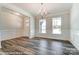 An elegant dining room with wainscoting, a chandelier, and windows bringing in natural light at 2227 Caravan Ln # 43, Denver, NC 28164