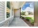 A cozy porch showcasing stone accents, sturdy wooden beams and lush landscaping at 2227 Caravan Ln # 43, Denver, NC 28164