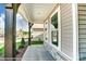 A welcoming front porch showcasing stone accents, sturdy wooden beams and lush landscaping at 2227 Caravan Ln # 43, Denver, NC 28164