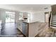 Open-concept kitchen with an island, stainless dishwasher and sink, and easy access to the living area at 2227 Caravan Ln # 43, Denver, NC 28164