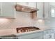 Close-up of the kitchen with stainless steel gas cooktop and stylish white herringbone backsplash at 2227 Caravan Ln # 43, Denver, NC 28164