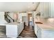 Open kitchen boasts white cabinets, an island, stainless appliances and leads to staircase at 2227 Caravan Ln # 43, Denver, NC 28164