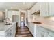 Modern kitchen featuring an island, stainless steel appliances, white cabinets, and open layout at 2227 Caravan Ln # 43, Denver, NC 28164