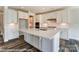Bright kitchen featuring a large island, white cabinets, modern countertops, and stainless appliances at 2227 Caravan Ln # 43, Denver, NC 28164