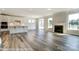 Spacious living room with an open floor plan including the kitchen, fireplace, and hardwood floors at 2227 Caravan Ln # 43, Denver, NC 28164
