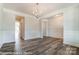 Bright living space featuring elegant wainscoting, modern light fixture, and wood floors at 2227 Caravan Ln # 43, Denver, NC 28164