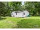 Spacious backyard featuring a white outbuilding and lush lawn at 2280 Cannon Farm Rd, China Grove, NC 28023