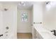 Bright bathroom featuring a shower-tub combo and a sleek vanity with modern fixtures and a window at 2280 Cannon Farm Rd, China Grove, NC 28023