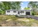 Charming renovated home with white brick exterior, black accents, and attached garage at 2280 Cannon Farm Rd, China Grove, NC 28023