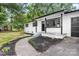 Stylish home featuring a renovated white brick exterior and landscaped walkway at 2280 Cannon Farm Rd, China Grove, NC 28023