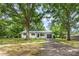Charming renovated home with white brick exterior, black accents, and driveway at 2280 Cannon Farm Rd, China Grove, NC 28023