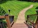 Backyard featuring well-maintained lawn and a brick walkway leading from a deck, perfect for outdoor enjoyment at 2777 Old South Nw Ct, Concord, NC 28027
