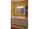 A bathroom with a white vanity, large mirror and industrial-style shelving for storage at 2777 Old South Nw Ct, Concord, NC 28027