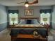 Bedroom featuring blue bedding, side tables, and windows at 2777 Old South Nw Ct, Concord, NC 28027