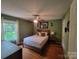 Bedroom featuring wood floors, green walls, and a window at 2777 Old South Nw Ct, Concord, NC 28027