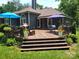 Multi-level deck features various seating arrangements and stylish outdoor decor for comfortable outdoor living at 2777 Old South Nw Ct, Concord, NC 28027