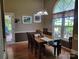 Bright dining room with hardwood floors, chandelier, and a large window overlooking the backyard at 2777 Old South Nw Ct, Concord, NC 28027