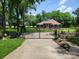 Lovely home with a gated entrance, well-maintained landscaping, and a welcoming driveway at 2777 Old South Nw Ct, Concord, NC 28027