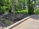 Natural creek bed with rock features and mature trees bordering the yard and driveway at 2777 Old South Nw Ct, Concord, NC 28027