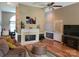Comfortable living room featuring a fireplace, hardwood floors, and ample natural light at 2777 Old South Nw Ct, Concord, NC 28027