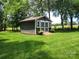 Charming outbuilding with flower boxes and a small deck, perfect for storage or a hobby space at 2777 Old South Nw Ct, Concord, NC 28027