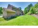 Large backyard with brick patio, lush green grass, and mature trees at 2785 Disney Pl, Indian Land, SC 29707