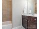 Cozy bathroom featuring a combined tub and shower, and a dark wood vanity at 2785 Disney Pl, Indian Land, SC 29707