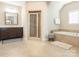 Bright bathroom features a tiled shower, a vanity with dark cabinets, and a soaking tub at 2785 Disney Pl, Indian Land, SC 29707