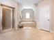 Bright bathroom features a tiled shower, soaking tub, neutral color scheme, and large tile flooring at 2785 Disney Pl, Indian Land, SC 29707