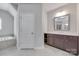 Bathroom with a soaking tub, tiled floors, and vanity with dark cabinets at 2785 Disney Pl, Indian Land, SC 29707