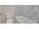 Bathroom featuring a toilet and a bathtub with tiled walls at 2785 Disney Pl, Indian Land, SC 29707