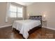 This bedroom features hardwood floors, a large window, and a comfortable bed at 2785 Disney Pl, Indian Land, SC 29707
