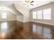 Large bonus room featuring hardwood floors, multiple windows, and ceiling fans at 2785 Disney Pl, Indian Land, SC 29707
