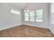 A bright dining room with hardwood floors and three large windows providing lots of natural light at 2785 Disney Pl, Indian Land, SC 29707