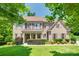 Charming two-story brick home with manicured lawn, mature trees, and a covered front porch at 2785 Disney Pl, Indian Land, SC 29707