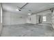 Spacious garage features concrete floor, shelving, and overhead lighting at 2785 Disney Pl, Indian Land, SC 29707